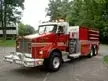 Front-left exterior view showing cab, bumper, and tank body