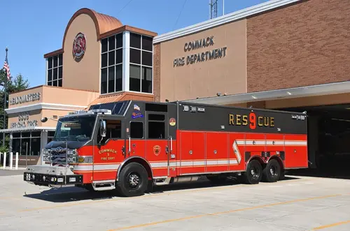 Heavy rescue truck driver-side profile view showing long body and tandem rear axles