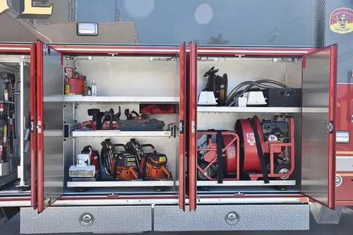 Open long side compartment showing rescue tools and bag storage