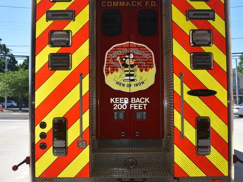 Rear view showing red-and-yellow chevrons and center rear compartment door