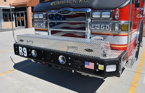 Front bumper close-up showing grille, intake ports, and warning lights