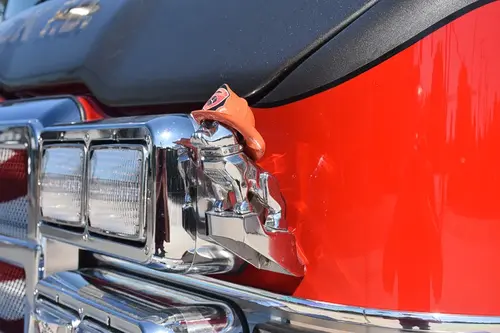 Cab-side detail close-up showing body badge and trim on red panel