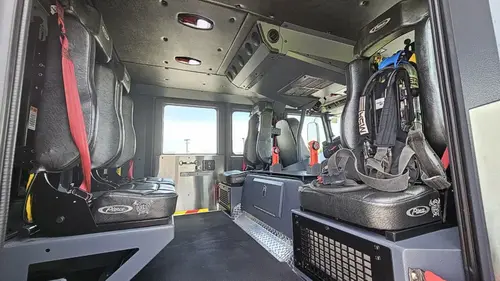 Cab interior wide view showing rear seating and center console area