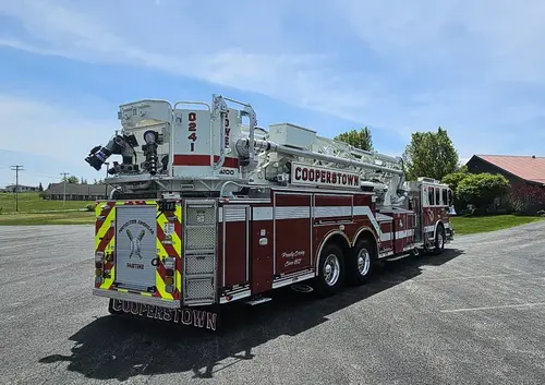 Rear-left exterior view showing ladder bed, turntable area, and rear chevrons