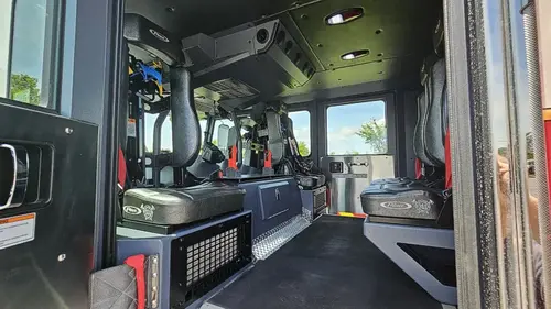 Cab interior view through open door showing seat row and aisle