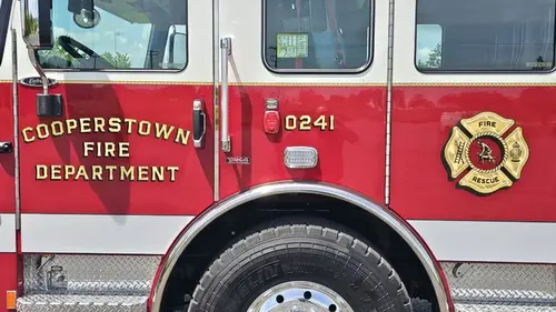 Cab-side close-up showing door lettering and crest emblem