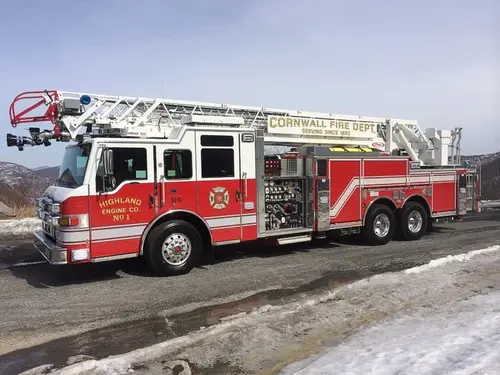 Tower ladder front-left exterior view showing enclosed cab and aerial sections