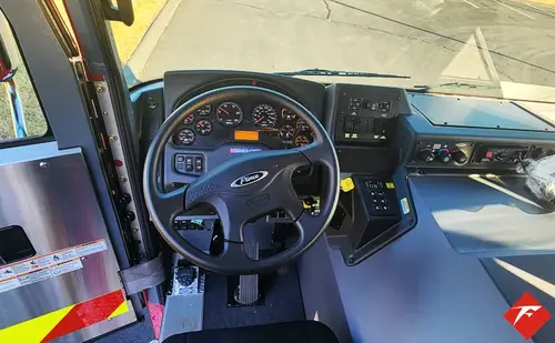 Driver cockpit view showing steering wheel, dashboard, and center controls
