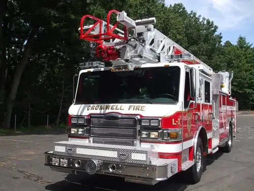 Front-right exterior view showing bumper, cab, and ladder tip