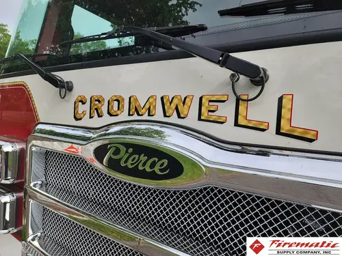 Front grille close-up showing mesh grille and emblem badge