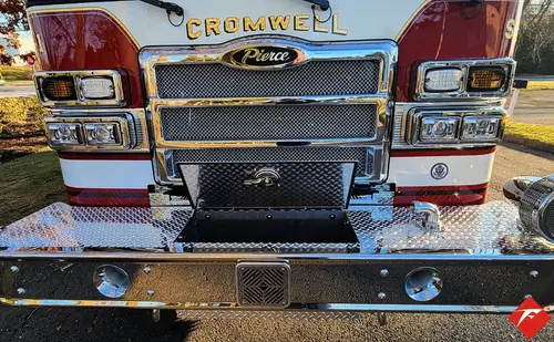 Head-on front view showing grille, bumper intake, and warning lights
