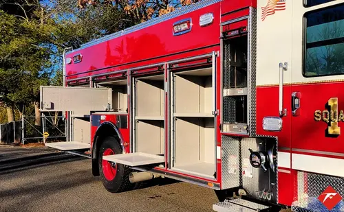 Officer-side profile with open compartments showing shelf and tool storage