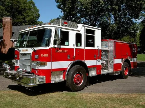 Pumper front-left exterior view showing enclosed cab and side compartments