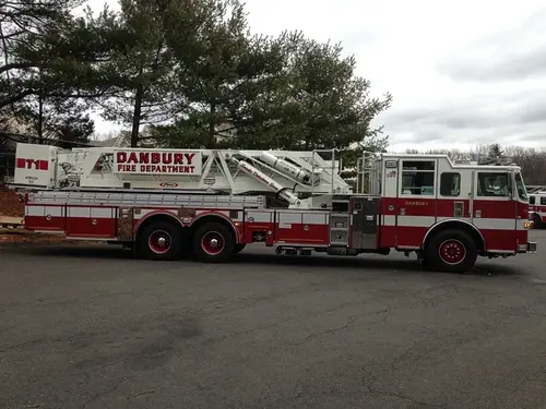 Passenger-side full profile showing ladder bed and rear bucket section