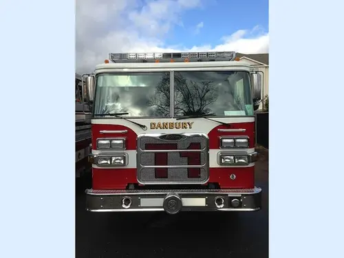 Head-on front view showing grille, bumper, and warning lights