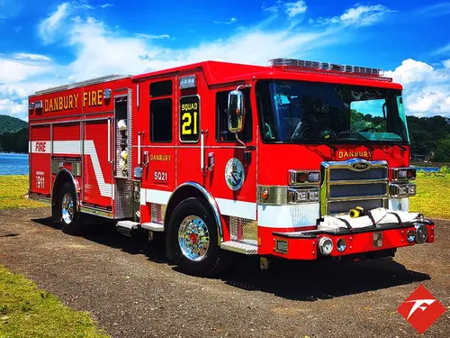 Rescue pumper front-left exterior view showing enclosed cab and side body