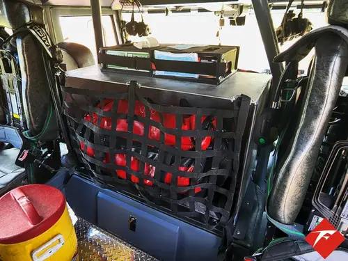 Rear crew cab interior view showing seat backs, restraints, and center aisle