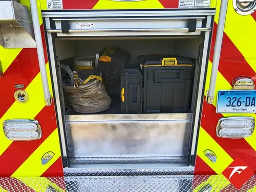 Rear compartment close-up showing stored cases and open center bay