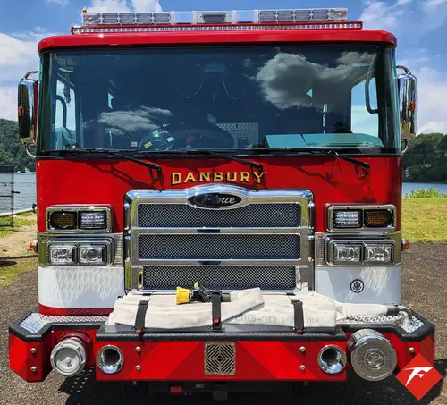 Head-on front view showing grille, bumper intake, and warning lights
