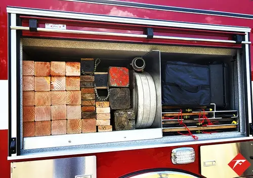 Open side compartment showing box storage and shelf-mounted gear