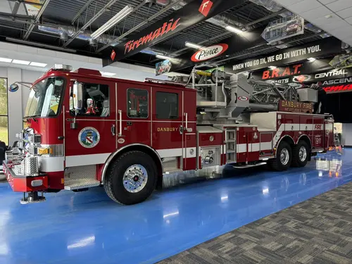Danbury Pierce Enforcer 100-foot aerial tower three-quarter side view in the apparatus bay