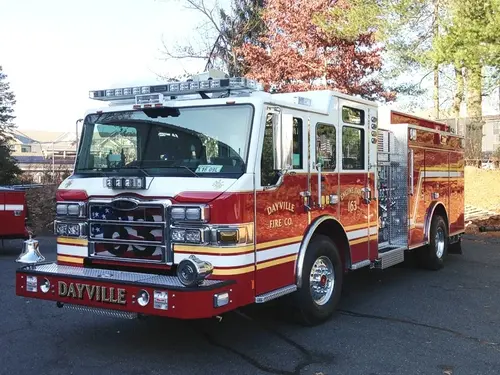 Pumper front-left exterior view showing enclosed cab and side compartments