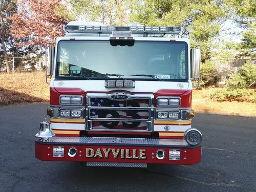 Front exterior view showing grille, bumper, and warning lights
