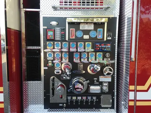 Pump panel close-up showing gauges, valves, and control levers
