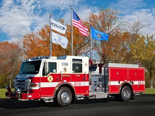 Pierce custom pumper front-left exterior view with enclosed cab and side compartments