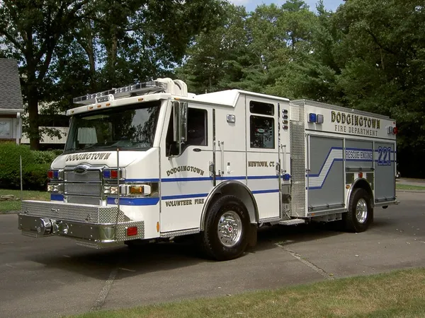 Rescue pumper front-left exterior view showing enclosed cab and side compartments