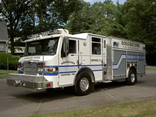 Rescue pumper front-left exterior view showing enclosed cab and side compartments