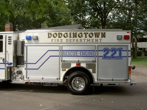 Driver-side profile view showing long rescue body and wheel area