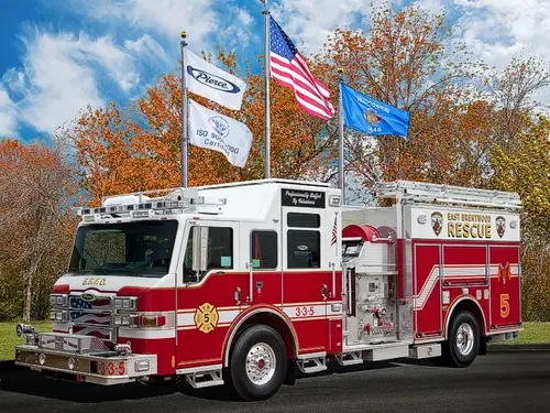 Pierce rescue pumper front-left exterior view with roof ladders and side compartments