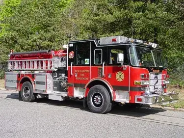 Pumper front-left exterior view showing enclosed cab and side compartments