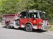 Pumper front-left exterior view showing enclosed cab and side compartments
