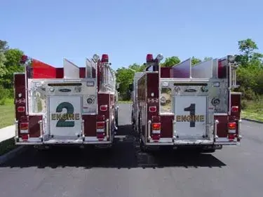 Rear view showing two pumpers with rear chevrons and tailboards