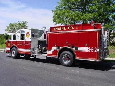 Driver-side full profile showing pumper body and pump panel area