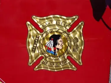 Cab door close-up showing Maltese-cross style crest on red panel