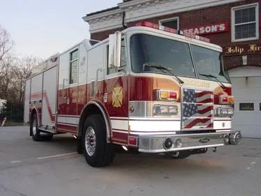 Rescue truck front-left exterior view showing enclosed cab and long body
