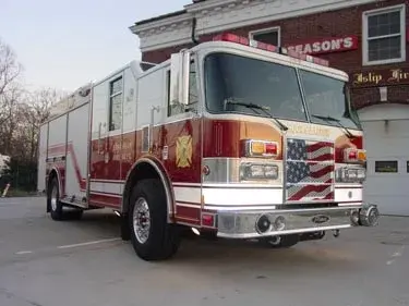 Rescue truck front-left exterior view showing enclosed cab and long body