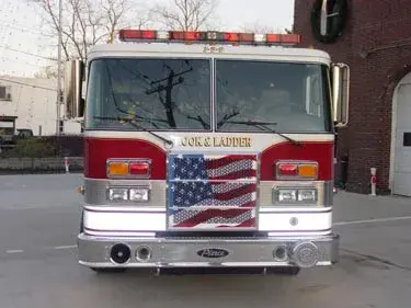 Front exterior view showing grille, bumper, and warning lights