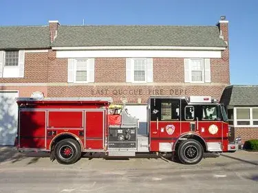 Full right-side profile showing side compartments, midship pump panel area, and rear wheel section.