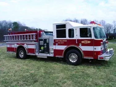 Pumper front-left exterior view showing enclosed cab and side compartments
