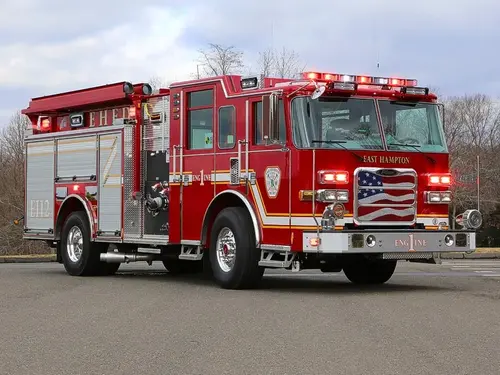 Pumper front-left exterior view showing enclosed cab and side compartments