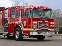 Pumper front-left exterior view showing enclosed cab and side compartments