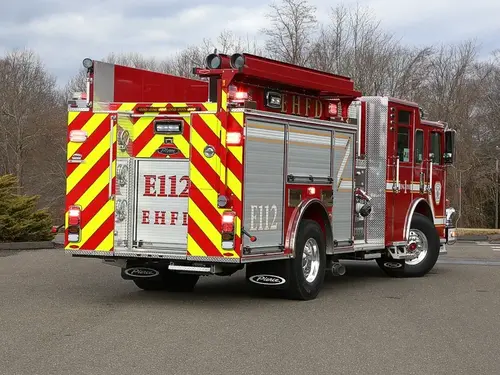 Rear-right exterior view showing side hosebed rails and rear wheel area