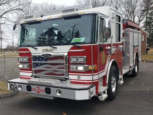 Pumper front-left exterior view showing grille, bumper, and enclosed cab