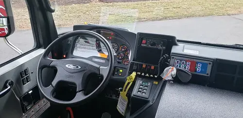Driver cockpit view showing steering wheel, dashboard, and control console