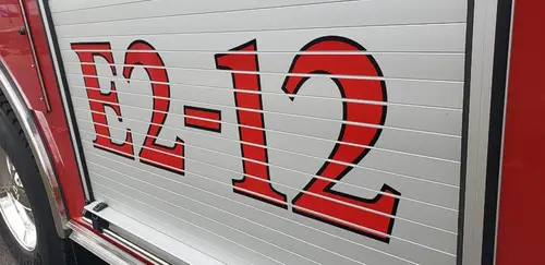 Body side close-up showing large unit number on roll-up door