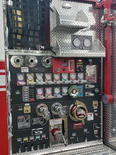 Pump panel close-up showing gauges, valves, and intake controls